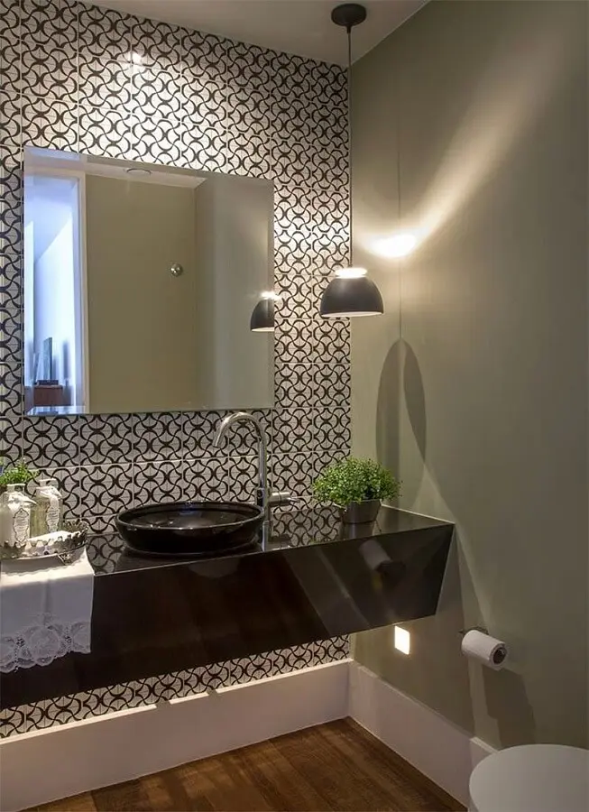 banheiro moderno decorado com azulejo estampado e luminária de teto sobre bancada preta Foto LA Interiores