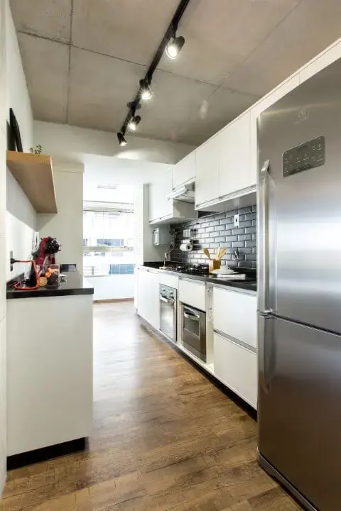 Cozinha planejada com piso vinílico e armários brancos Projeto de Fabiana Montandon
